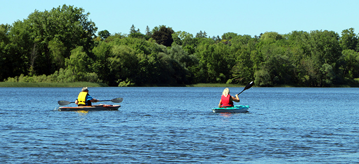 Two people kayaking on a large lake