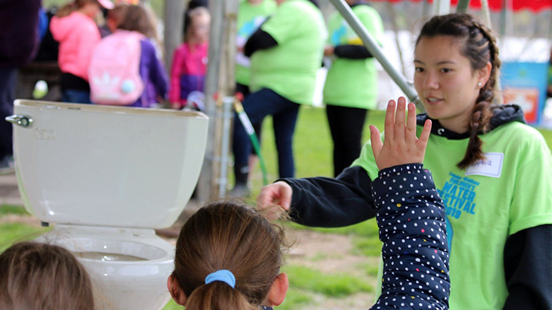 Children listen to a volunteer at the London Middlesex Children's Water Festival