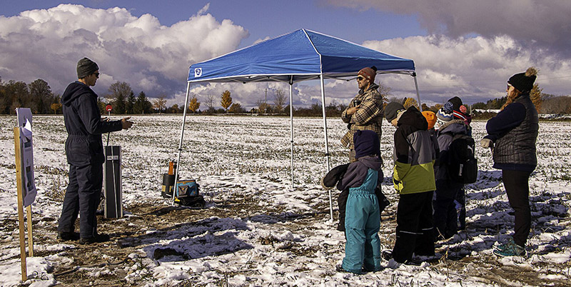 UTRCA staff talk with landowners in a snowy field at the Demonstration Farm Conservation Field Day