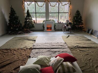 Pillows and blankets set up in front of a faux fireplace