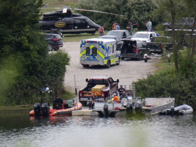 Film crew, helicopter, ambulance and boat dock side at Fanshawe Lake