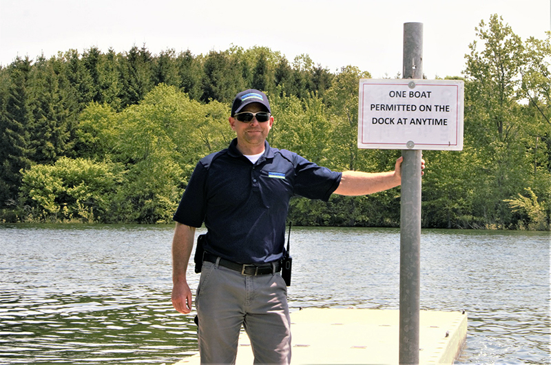 Person standing in front of a boat launch