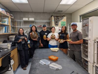 Scholars holding turtle shells in the Turtle Lab