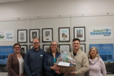 Award winners stand with UTRCA and county staff holding award