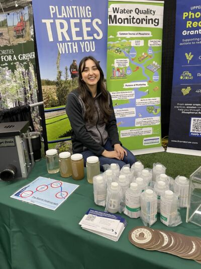 UTRCA staff at exhibition booth with water sample bottles on the table